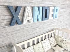 a baby's room with wooden letters and pillows