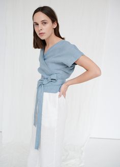 "SIZING & FIT This garment is true to size, and we recommend choosing the size you usually wear. If you want the garment to be loose-fitting, choose a larger size than you usually wear. Before placing an order, check the approximate measurements of the finished garment given below. Model is 5′6″ (170cm) tall with an 80cm/31″ bust, 68cm/26″ waist, 91cm/35″ hip, and she is wearing an XS in dusty blue. XS Length ± 50cm | 19.7\" Bust ± 96cm | 37.8\" Sleeve length from neckline ± 23cm | 9.1\" Sle Chic Linen V-neck Top, Blue Linen V-neck Blouse, Fitted Linen Blouse For Spring, Blue Linen Blouse For Spring, Spring Blue Linen Blouse, Chic Linen Tops With Relaxed Fit, Chic Relaxed Fit Linen Tops, Fitted Linen Top For Spring, Blue Linen Tops For Spring