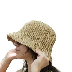 This hat is 100% handmade and crafted from raffia yarn. Raffia yarn is a natural and durable material, ensuring the hat's longevity. The wide brim of the hat is perfect for sun protection and offers a stylish look. This beige hat stands out with its simple and elegant design. It is an excellent accessory for both everyday use and outdoor activities like the beach. Its comfortable and lightweight structure ensures easy and prolonged wear. Raffia. You can store this hat, knitted from raffia rope, in a breathable cloth bag, protect it from fire and heat, and wipe the stains with a clean damp cloth. Beige Straw Panama Hat With Curved Brim, Eco-friendly Toquilla Straw Hat, Brown Woven Straw Hat, Natural Woven Wide Brim Bucket Hat, Wide Brim Natural Woven Bucket Hat, Wide Brim Woven Bucket Hat In Natural, Natural Straw Bucket Hat With Flat Brim, Beige Toquilla Straw Hat With Short Brim, Woven Straw Bucket Hat With Flat Brim