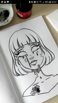 a drawing of a woman's face on top of a white paper with black ink