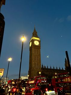 the big ben clock tower towering over the city of london, england at night time