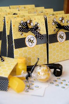 small yellow bags with black and white designs on them sitting on top of a table