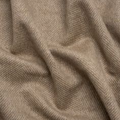 Brave the cold in this Dark Beige and Cream Herringbone Brushed Wool Blend Twill Coating, displaying a dark beige and cream herringbone pattern across its fuzzy, slightly tactile face and reverse. It features a subtle luster and a malleable drape. A lining will increase warmth and structure but is not necessary.

An easy way to elevate your look while staying warm, high-quality wool outerwear brings a chic maturity to your street, corporate, or formal style. The impact of a wool coat—be it oversized, fitted, wrap-around, or trench—is timeless, promoting practical fashion through a heavyweight feel. Though the wind is sharp, you’ll suddenly find yourself eager to walk the cold city streets in your new winter staple... (thank you, Mood!) Woollen Fabric, Mood Designer Fabrics, Herringbone Texture, Twill Coat, Herringbone Fabric, Practical Fashion, Mood Fabrics, Stripe Silk, Diagonal Stripes