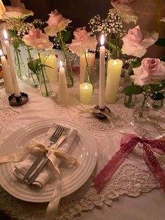 the table is set with candles and flowers