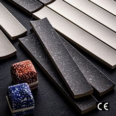 several pieces of wood sitting next to each other on a black surface with white and blue designs