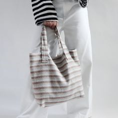 Our everyday casual tote bag is crafted of a striped woven linen-cotton blend in neutral, earthy tones. This bag has a lightweight feel but is durable enough to tote all you need for a day at the beach. Our tote is fully lined in Natural Twill and includes a zipper pocket and 2 slip pockets.  A simple design in an  eco-friendly fabric of natural fibers with no un-necessary frills.     Simple, Summer style at its best. Details: 14in H x 5in D x 17in W at top, 12in W at bottom Approximately 9 in h Coastal Casual, Simple Summer Style, Vacation Bag, Casual Tote Bag, Summer Linen, Steam Iron, Linen Bag, Pencil Bags, Day At The Beach