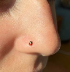 a close up of a person's nose with a small red dot on it