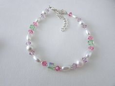 "Pearl bracelet, pastel bracelet, Swarovski bracelet Beautiful pastel bracelet featuring Swarovski pink, light amethyst, and peridot crystals, white glass pearls added elegance, quality silver plated lobster clasp and silver chain extension complete this custom made bracelet. BRACELET fit up to 8\". Fuchsia Sapphire Bracelet https://www.etsy.com/listing/228132651/sapphire-fuchsia-bracelet-swarovski?ref=related-5 Bracelet Collection https://www.etsy.com/shop/minieglamstudio?section_id=7077497 ♥Fr Pastel Round Beads Jewelry Gift, Handmade Pastel Jewelry For Birthday, Elegant Adjustable Pastel Bracelets, Pink Bracelet Jewelry For Birthday, Pastel Bracelet Jewelry As Gift, Pink Birthday Bracelet With Lobster Clasp, Elegant Pastel Bracelets As Gift, Elegant Pastel Bracelets For Gifts, Metal Bead Bracelet