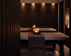 a spa room with candles and towels on the tables