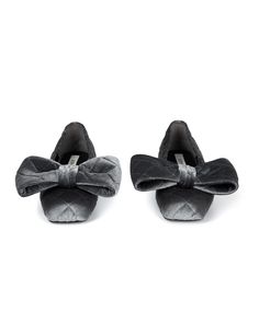 two pairs of black shoes with bows on the front and back side, both in velvet