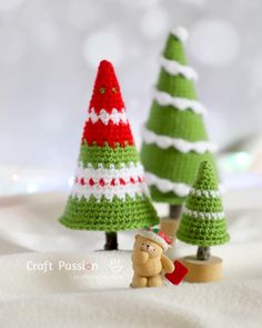 small crocheted christmas trees and a teddy bear