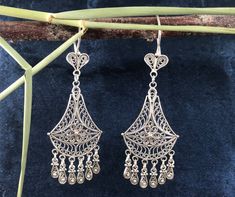 Our  Chandelier /Dangle Boho) filigree women's earrings are made of  925 sterling silver.  Specially oxidized to achieve the authentic look. Weight; 9g Size: approx 6.7cm x 2.6cm Our company started its activities in 2019, has recently decided to open the silver jewelery which is produced highly qualified and in a unique style with the filigree technique at the local level, to the world markets and has started its activities for this purpose. Researches by archaeologists reveal that silver jewelry has been accepted as an indispensable product since ancient times. Again, researches reveal that people have produced ideas on silver jewelry and produced different techniques for jewelry making throughout history. One of the most striking of these techniques is the filigree technique. Filigree i Sterling Silver Filigree Dangle Chandelier Earrings, Filigree Sterling Silver Chandelier Earrings For Gift, Sterling Silver Filigree Chandelier Earrings As Gift, Sterling Silver Filigree Chandelier Earrings, Classic Filigree Chandelier Earrings As Gift, Classic Filigree Dangle Chandelier Earrings, Classic Filigree Chandelier Earrings For Gift, Classic Filigree Chandelier Dangle Earrings, Classic Filigree Chandelier Earrings