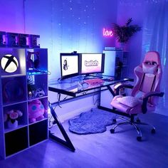 a desk with two computer monitors and a pink chair