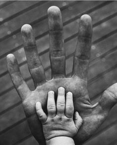 a black and white photo of a person's hand holding up the middle finger