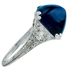 For Sale on 1stdibs - Captivating platinum art deco ring featuring a magnificent A.G.L certified sugarloaf cabochon weighing 11.92 carats from Cambodia with no heat. The band Luxury Sapphire Ring In Oval Cabochon Shape, Luxury Elegant Sapphire Cabochon Ring, Luxury Platinum Sapphire Cabochon Ring, Luxury Sapphire Cabochon Ring, Luxury Vintage Sapphire Cabochon Ring, Deco Ring, No Heat, Art Deco Ring, Cambodia