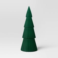 a green plastic christmas tree on a white background