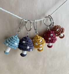 four crocheted key chains hanging from a rope