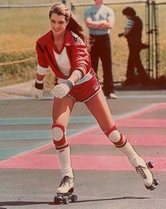 a woman in red and white skating on the street