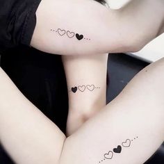 two women with matching tattoos on their arms