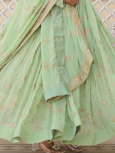 Introducing our stunning "precious pista green sequins georgette engagement wear anarkali gown," the perfect outfit for your special occasions. This exquisite gown comes in a beautiful pista green color with intricate zari embroidery and sequin work, adding a touch of elegance and glamour to your look. The gown is fully stitched and available in sizes ranging from XS to XXL, ensuring a perfect fit for every body type. With a 3.5-meter flair and a length of 56 inches, this gown is sure to make yo Pista Green Georgette Anarkali Set With Traditional Drape, Elegant Pista Green Dress With Gota Work, Green Anarkali Set For Diwali Reception, Pista Green Floor-length Dupatta With Gota Work, Festive Green Anarkali Set For Reception, Green Maxi Length Choli With Dupatta, Green Georgette Anarkali Set With Sheer Dupatta, Green Anarkali Sharara For Reception, Green Sharara For Reception