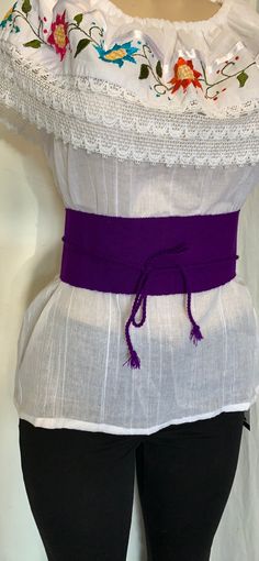 "Discover the allure of our exquisite Mexican Faja, a symbol of timeless chic. Crafted with precision, this belt is a canvas of beauty, adding a pop of color to any ensemble. Key Features: Color: Purple Size: Fits Most Sizes Belt Dimensions: Width: 3 3/4\" Length: 29.5\" Braided Section: 25\" Additional Details: Embroidery: Traditional Mexican embroidery adds a touch of artistry. Folk Fabric Flowers enhance the belt's cultural charm. This 100% authentic Mexican belt is more than an accessory; it's a piece of living tradition. Whether you're looking to add flair to your outfit or celebrate Mexican craftsmanship, this gorgeous green belt is a perfect choice. Elevate your style with the vibrant allure of our Beautiful Solid Color Mexican Faja." Elegant Fabric Beach Belt, Elegant Fabric Belt For Beach, White Fabric Belt For Summer, Elegant Fabric Belt For Summer, Elegant Belts For Beach, Elegant Embroidered Summer Belt, Elegant Summer Fabric Belt, White Adjustable Fabric Belt, Mexican Belt