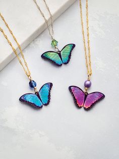 Pulsing with energetic color and the most exquisite detail, Holly Yashi's design team dared to stretch their imaginations and talents. The result: this breathtaking Bella Butterfly Pendant Necklace. Wear it as a symbol of change and endurance, a celebration of warm weather days, or to take a simple ensemble to the next level. Style Number: 19695 Metal: Gold Overlay Chain with Niobium Gemstones: Austrian Crystal Dimensions: adjustable between 16, 18 and 20 inches long with 3/4 inch drop Handmade Symbol Of Change, Holly Yashi, Detailed Necklace, Resin Jewellery, Butterfly Pendant Necklace, Butterfly Bracelet, Gold Overlay, Butterfly Jewelry, Long Pendant