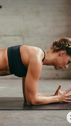 a woman is doing push ups on her stomach