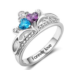 two hearts shaped ring with the words forever love engraved on it