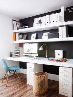 a white desk sitting under a computer monitor on top of a wooden floor