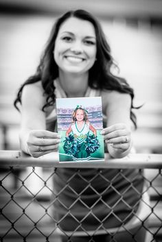 a woman holding up a card in front of her face with the image of a cheerleader on it