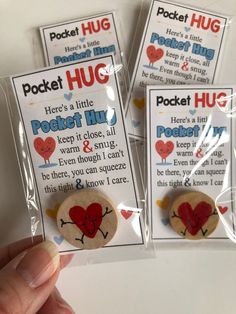 three pocket hug magnets are shown in the package, one has a red heart on it