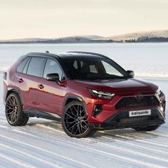 a red toyota rav parked in the snow