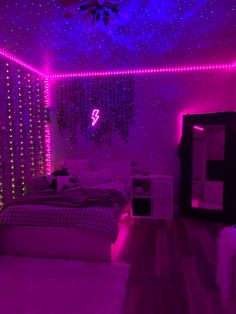 a bedroom with purple lights on the ceiling, and a bed in front of it