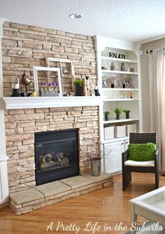 a living room filled with furniture and a fire place in front of a brick fireplace