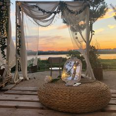 an outdoor setting with lights and decorations on the ground, including a large round wicker basket