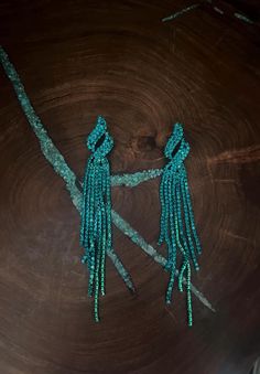 Teal green long fringe earrings  Size: .75 wide by 4 inches long Green Beaded Dangling Earrings For Party, Turquoise Earrings For Evening, Bohemian Green Chandelier Earrings For Party, Glamorous Green Chandelier Earrings For Evening, Turquoise Dangle Chandelier Earrings For Party, Green Chandelier Earrings For Evening, Long Drop Beaded Fringe Earrings For Party, Party Long Drop Earrings With Beaded Fringe, Green Beaded Drop Earrings