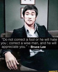 a man sitting on top of a couch next to a quote from bruce lee