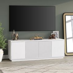 a living room scene with focus on the entertainment center and mirror in the background,