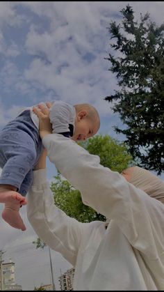 a man holding a baby in his arms