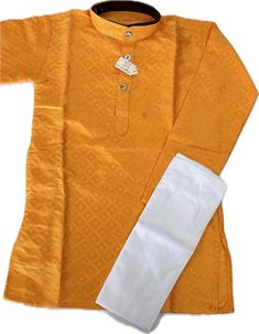 Fabric: Art Silk Top: Fully stitched Pant: Fully stitched Size: 2 Years Dress your little prince in style with this golden orange kurta designed specifically for 2-year-old boys. The set comes with a pair of white pants to complete the traditional Indian look. Made of high-quality art silk material, this kurta is not only comfortable but also durable, perfect for the active lifestyle of young children. Whether it's for a special occasion or just a casual day out, this kurta is the perfect choice for dressing up your little one. Get your hands on this stylish kurta set and make your child stand out in the crowd. *Dry clean only *Note: The fabric colors you see on our website may vary slightly depending on the color variations of each photograph, lighting, specific monitor, and settings. --- Fitted Cotton Kurta For Puja, Yellow Kurta With Pallu For Summer, Fitted Orange Kurta For Summer, Fitted Orange Sets With Chikankari Embroidery, Summer Cotton Kurta For Puja, Fitted Orange Kurta For Diwali, Summer Cotton Sets With Pallu, Fitted Yellow Self Design Kurta, Orange Cotton Sets For Diwali