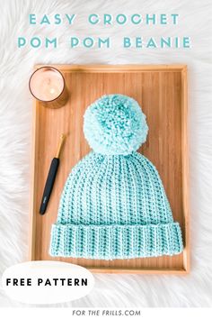 the easy crochet pom - pom beanie pattern is shown on a tray