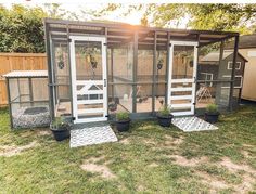 an outdoor chicken coop in the backyard with potted plants and other things around it