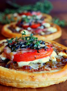 small pizzas with tomatoes, cheese and herbs