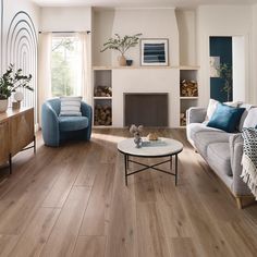 a living room filled with furniture and a fire place in the middle of the room