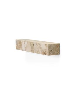 a white marble shelf sitting on top of a wall