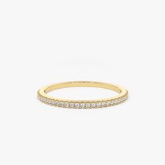 a yellow gold band with white diamonds on the inside and outside, set against a plain background