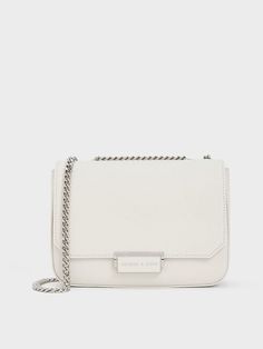 This product is made with at least 20% sustainable materials by weight. CHARLES & KEITH uses recycled, degradable, organic, and water-based materials in our eco-conscious collection. White and silver make for a timelessly chic combination, especially when seen on this classic chain strap shoulder bag. It is roomy enough to hold all your daily essentials when you are on the go, while looking clean, compact and polished. Reach for this to instantly elevate your white tee and jeans ensemble - it is the perfect companion for errand runs and lunch breaks. White Tee And Jeans, Size Chart For Kids, Charts For Kids, Charles Keith, Printables Kids, Daily Essentials, White Tee, Sustainable Materials, Belt Size