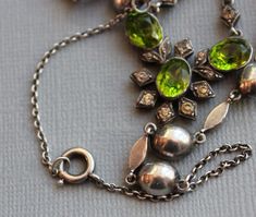 "Entrancing and very rare Georgian necklace, circa 1800 Peridot green foiled paste jewels accented with diamond paste spacers. The green paste stones glow in the light. Rivieres with drops like this are incredibly difficult to find! Measurements\" Necklace - 19\" with an additional 1 3/4\" for the drop Each green paste - 1/2\" with loops Light wear, fitting for age. No damage or repairs to note. Please note, insurance is not included in the postage cost. Please contact me for a quote if interest Green Pendant Necklace With Diamond Accents, Green Victorian Necklace For Wedding, Antique Green Jeweled Necklace, Antique Green Jeweled Necklaces, Ornate Green Jewelry With Jewels, Vintage Green Jewelry With Rose Cut Diamonds, Antique Green Necklaces For Weddings, Oval Green Jeweled Jewelry, Formal Green Jewelry With Rose Cut Diamonds