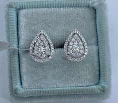 Sparkling Pear Shape Cluster Diamond Stud Earrings.  The Round brilliant diamonds are white and very sparkling.  Beautiful shape on the ear.  These earrings will be your go to earrings for any occasion, dress up or down.  The backings snap on tight for a secure fit.  These are good size studs, not too small and not too big.  Measures 11.2 x 8.2mm.  Clean clean diamonds, no black carbon spot even when viewed under a magnifying glass.  Sits low on the ears so all you see are sparkly diamonds.   Natural round brilliant cut diamonds total weight: 0.63 carats Clarity: SI Color: F 18K White Gold 2.10 grams  Comes with gift box * We have been in the wholesale Jewelry business for over 30 years serving the community at the same location.  All diamonds we use are natural stones and fine quality gol Diamond White Brilliant Cut Pear-shaped Bridal Earrings, Luxury Pear-shaped Diamond White Cluster Earrings, Fine Jewelry Pear-shaped Diamond Bridal Earrings, Diamond White Pear-shaped Bridal Earrings With Brilliant Cut, Pear-shaped White Gold Diamond Earrings With Accents, Fine Jewelry Bridal Earrings In Diamond White, Pear-shaped, White Teardrop Diamond Earrings In Platinum, Diamond White Pear-shaped Fine Jewelry Earrings, Elegant Gia Certified Teardrop Diamond Earrings