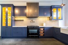 a kitchen with blue cabinets and an oven